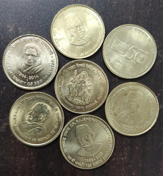 Seven different ₹5 commemorative coins.