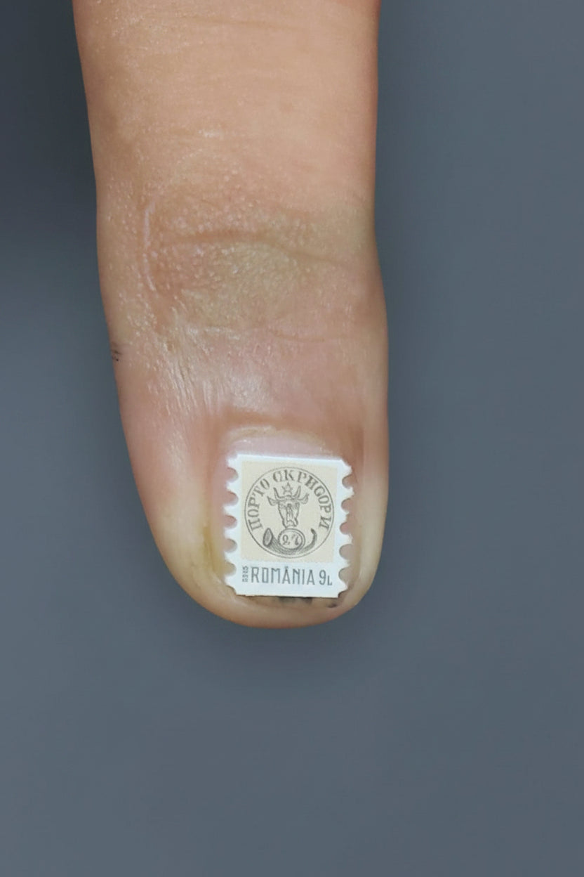 Romania - world's smallest stamp- smaller than your nails.