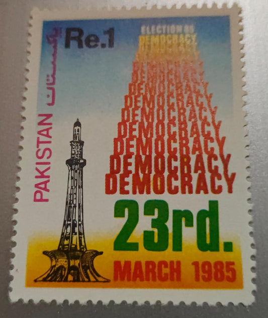 1985 Pakistani postage stamp commemorating the "Election '85" series.It features the Minar-e-Pakistan monument in Lahore and the word "DEMOCRACY" repeated to form a tower shape.