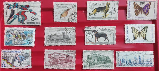 Ceskoslovensko 12 diff stamps - themes like sports olympics, birds, dogs, butterfly,  trains.