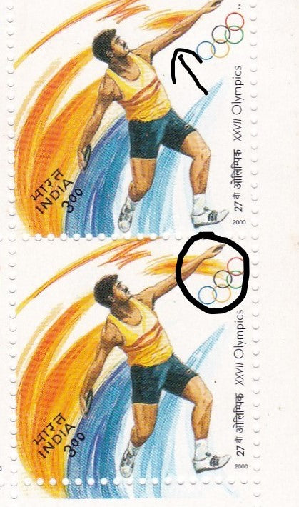 India Error-Extra design below left hand of athlete near Olympics rings.