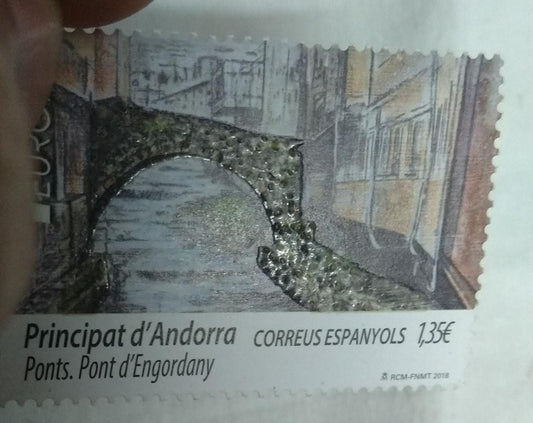 Andorra single stamp with real rock powder affixed .