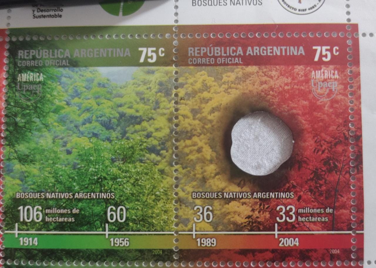 Argentina 2004 Setenent pair with one stamp having die cut hole - signifying the effects  of deforestation.